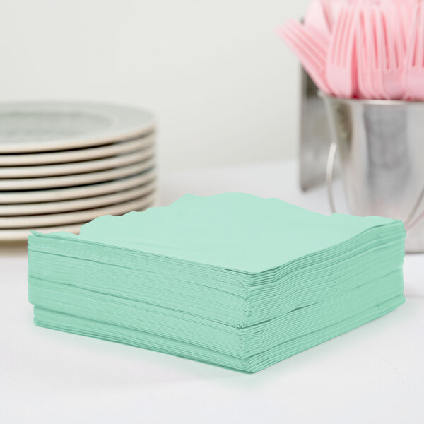 A stack of Creative Converting Fresh Mint Green 1/4 Fold Luncheon Napkins