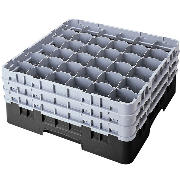 A black plastic Cambro glass rack with 36 compartments and 5 extenders.