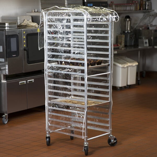 A metal bun pan rack with clear plastic covering it.