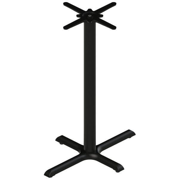 A FLAT Tech black cast iron table base with a cross base.