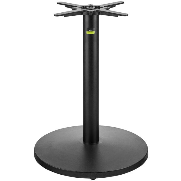 A FLAT Tech black cast iron table base with a metal stand.