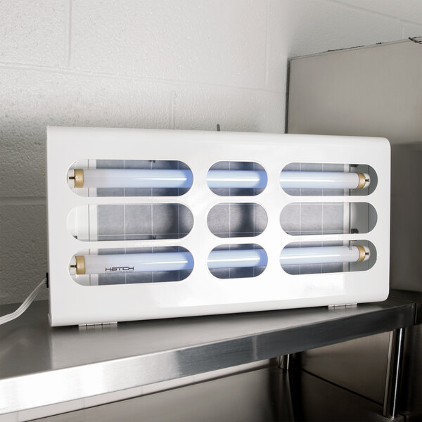 A white rectangular Curtron Pest-Pro BL200 flying insect control light with several fluorescent tubes inside.