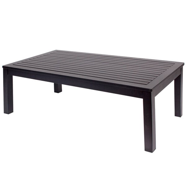 A black rectangular BFM Seating aluminum coffee table with a wooden top on an outdoor patio.