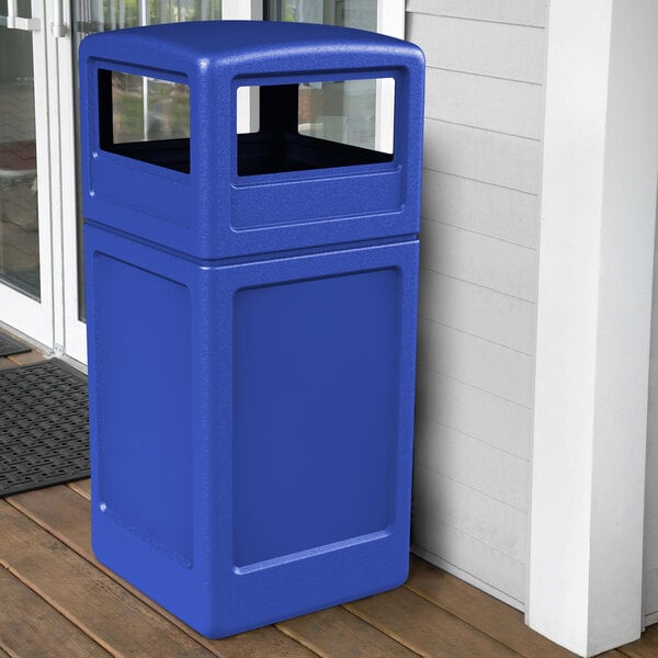 A blue Commercial Zone PolyTec square waste container on a porch.