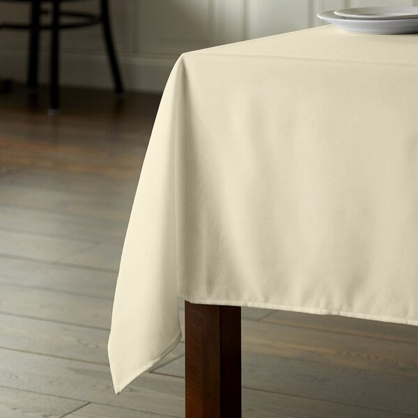 Intedge 54" x 72" Rectangular Ivory 100% Polyester Hemmed Cloth Table Cover