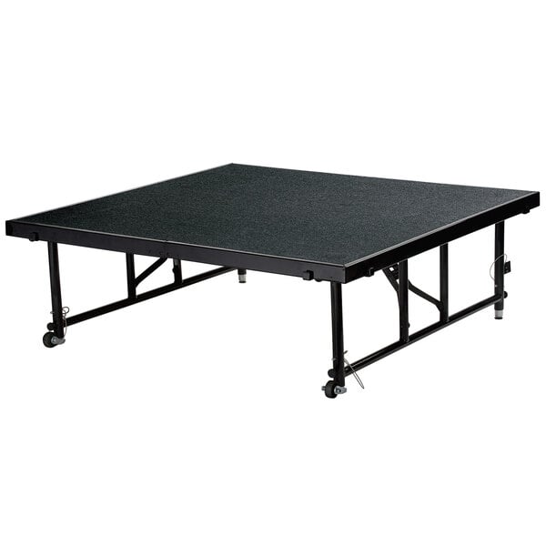 A National Public Seating Transfix black rectangular stage platform with wheels.