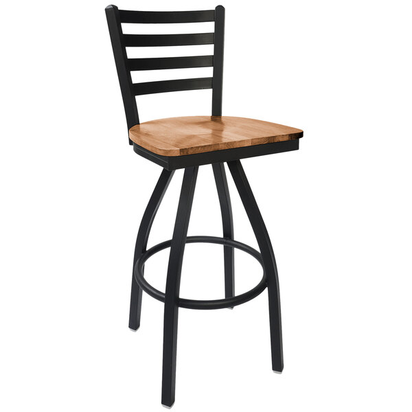 A BFM Seating black steel bar stool with a wooden swivel seat.