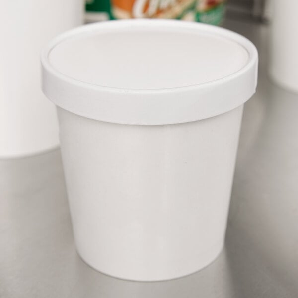 A white paper Choice double-wall food container with a paper lid.
