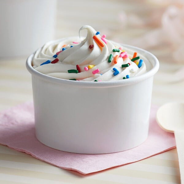A white paper Choice frozen yogurt cup filled with ice cream and sprinkles.