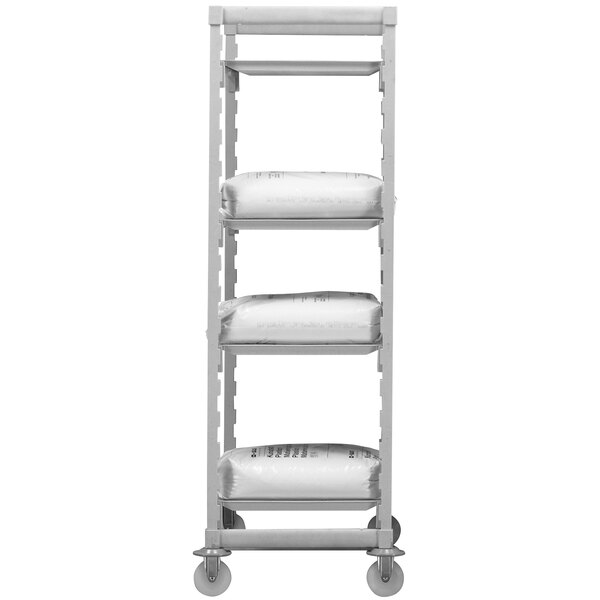 A white Cambro Camshelving® Premium mobile shelving unit with gray shelves holding white bags.