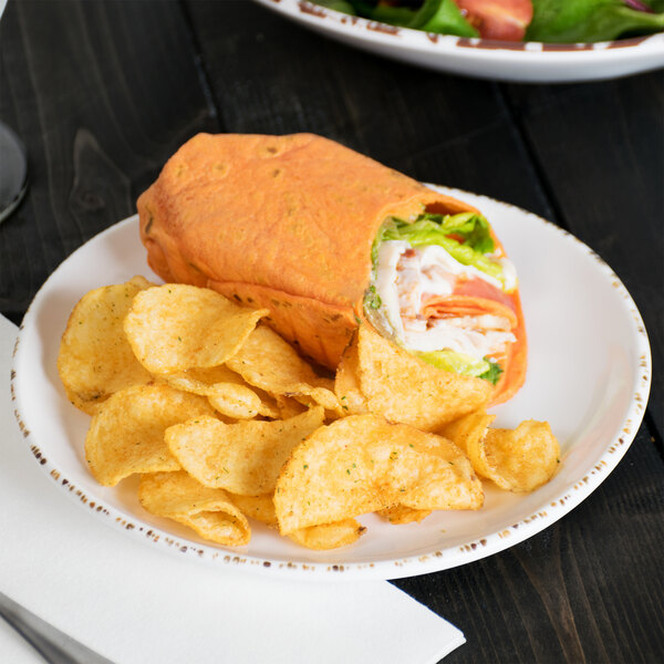 A tortilla wrap with chips and salad on a GET Urban Mill irregular round melamine plate.