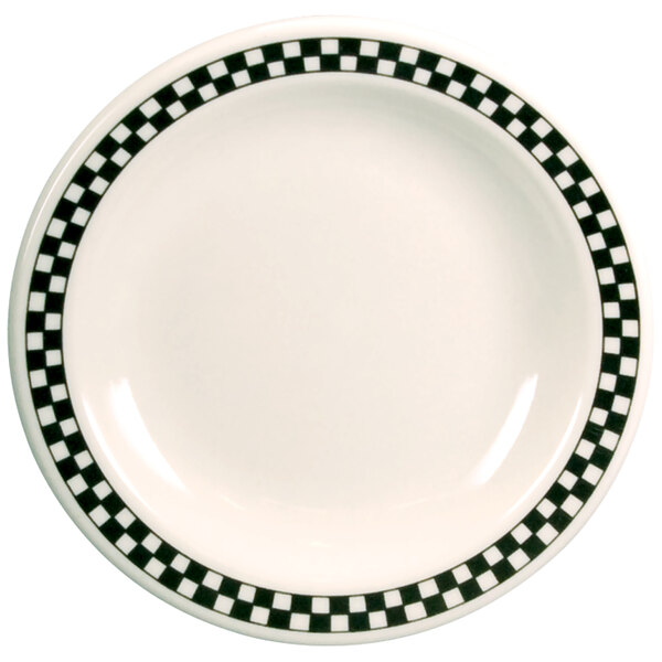 A white Homer Laughlin china plate with black and white checkered trim.