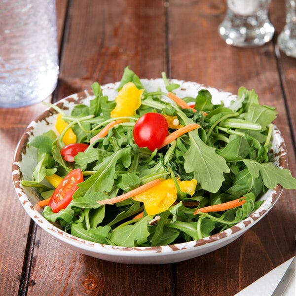 A French Mill melamine bowl filled with salad, carrots, and tomatoes.