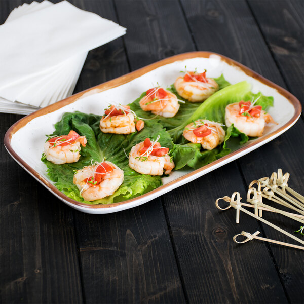 A Rustic Mill rectangular melamine platter with shrimp and lettuce on it.