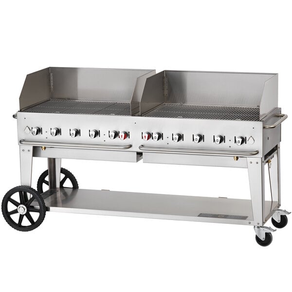 A Crown Verity stainless steel mobile outdoor grill with a wind guard.