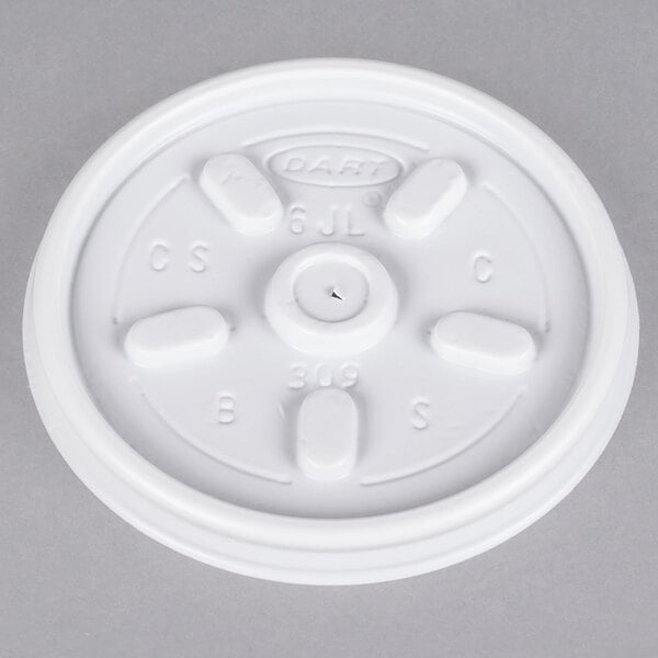 A white Dart plastic lid with four vent holes.