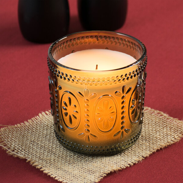 A Sterno flameless wax candle in a green glass holder.