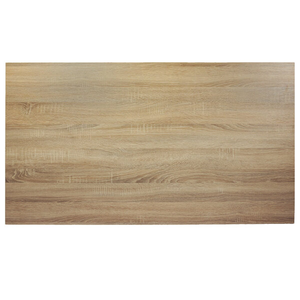 A close-up of a BFM Seating Sawmill Oak rectangular wood table top.