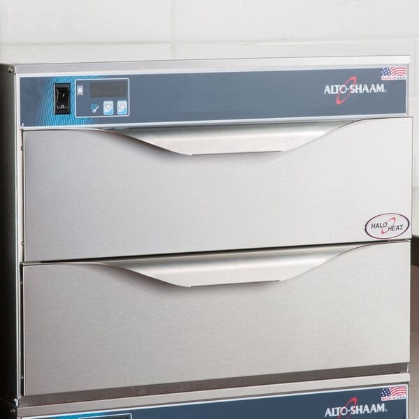 An Alto-Shaam 2 Drawer Warmer on a stainless steel counter.