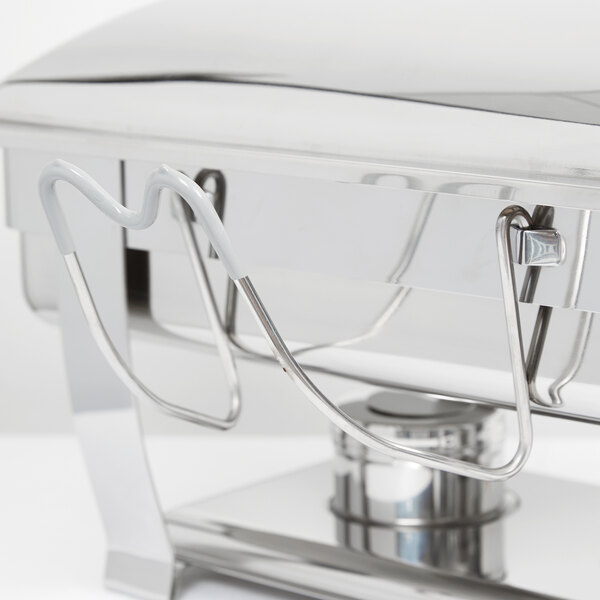 A stainless steel Vollrath Orion chafer cover holder with a hook on a counter.