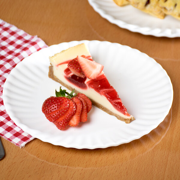 A slice of cheesecake with strawberries on an American Metalcraft melamine plate.