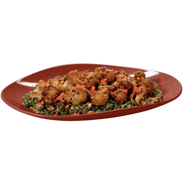 A chili red oval melamine platter with food on it.
