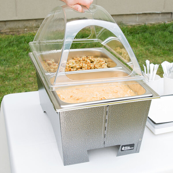 A Sterno Fold Away Chafer with food in containers on a table.
