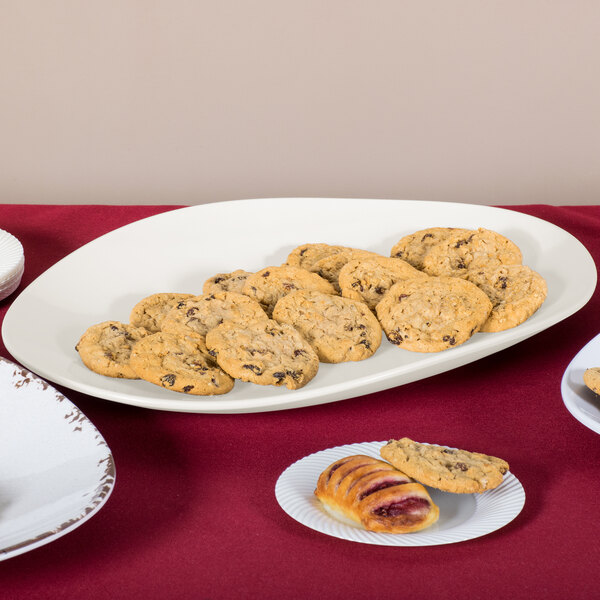 A platter of cookies on a table with other food items.