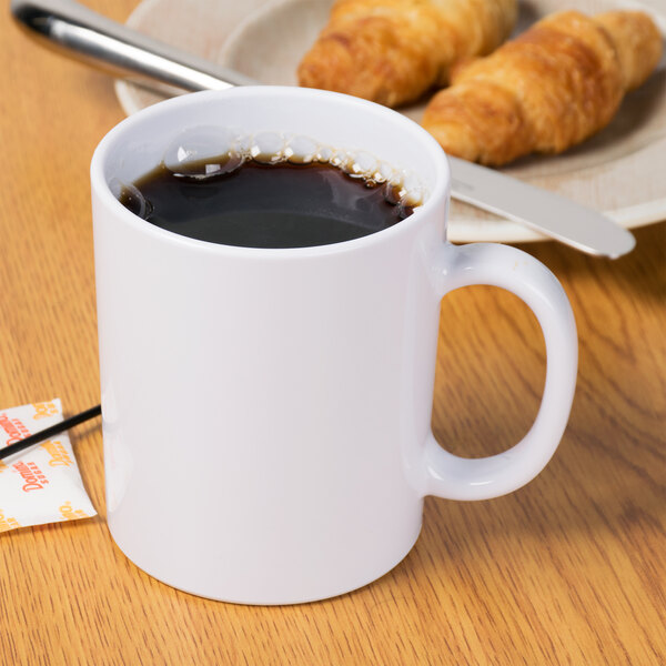 A white Tritan coffee mug with a croissant on a plate.