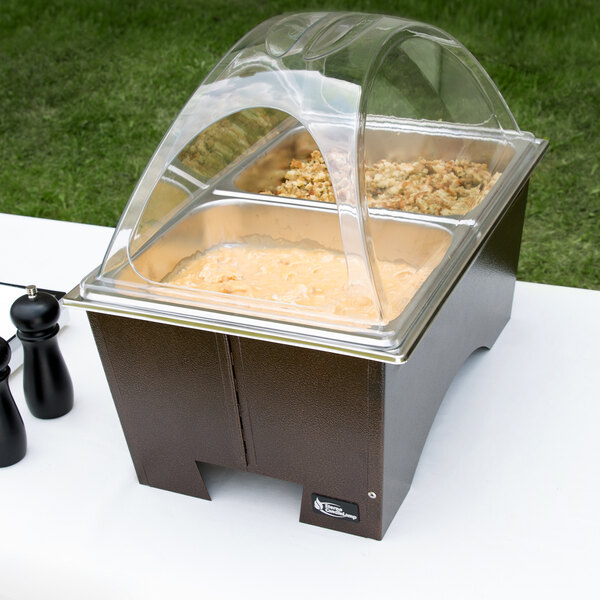 A Sterno Copper Vein chafing dish with clear dome lid and two half size pans on a table.