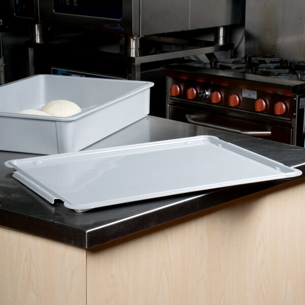 A white rectangular MFG Tray lid on a counter.