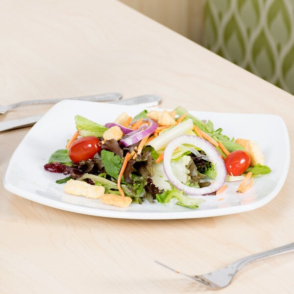 A Libbey bright white square porcelain plate with a salad and a fork.
