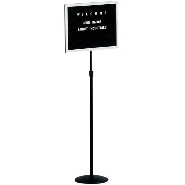 A black Aarco single pedestal stand with a black felt board sign and white letters.