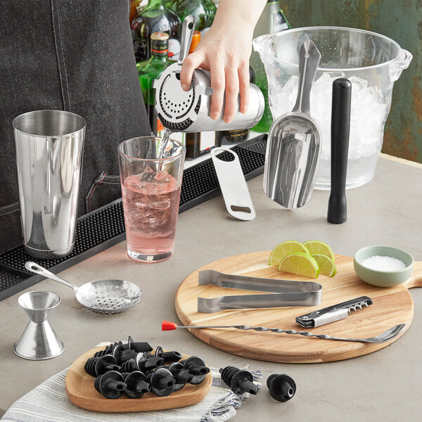 A person using the Choice Ultimate Cocktail Kit to prepare a cocktail.