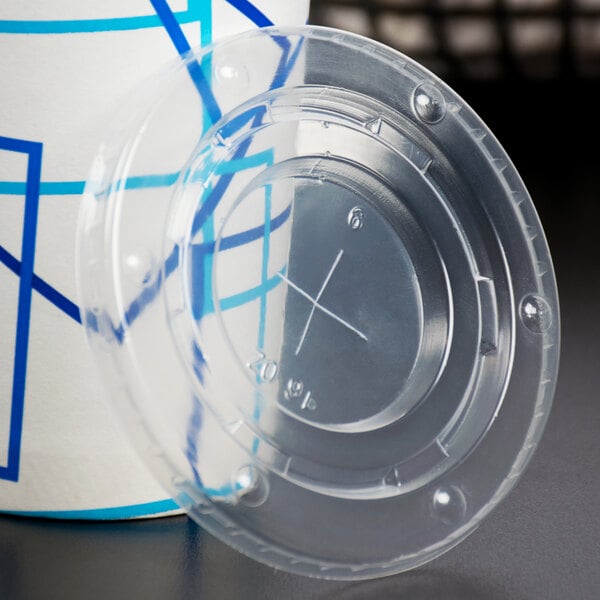 A translucent plastic Choice lid with a straw slot on a clear plastic cup.
