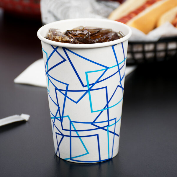 A Choice paper cold cup filled with ice tea on a table.