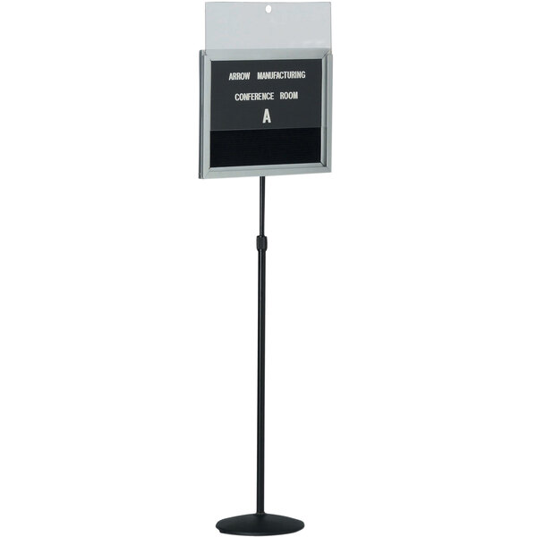 A black Aarco single pedestal sign with white letters on a stand.