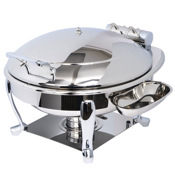 A stainless steel Eastern Tabletop Crown chafer with a hinged dome lid on a table outdoors.