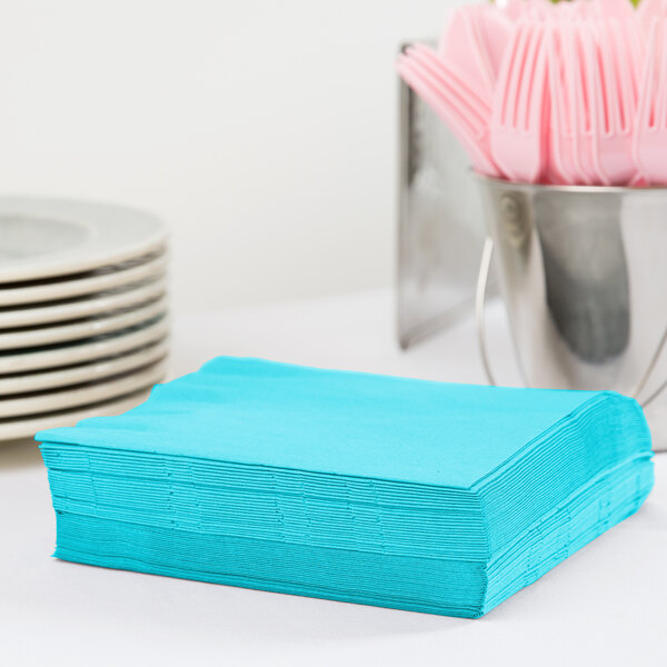 A stack of Bermuda blue Creative Converting luncheon napkins.
