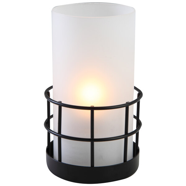 A white Sterno Gridiron lamp with a white candle inside on a black metal frame.