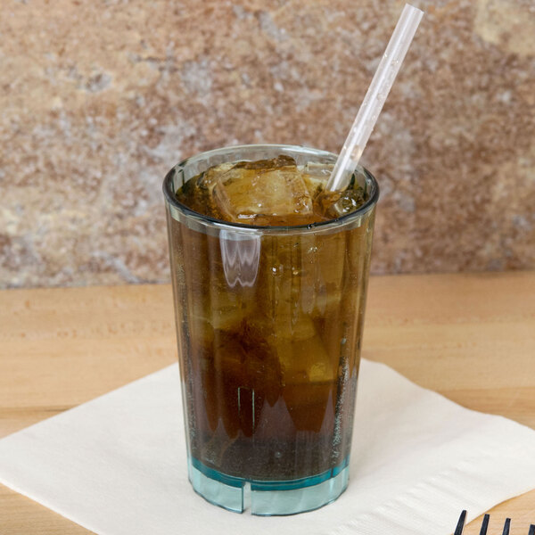A Cambro azure blue polycarbonate tumbler with a straw filled with brown liquid and ice.