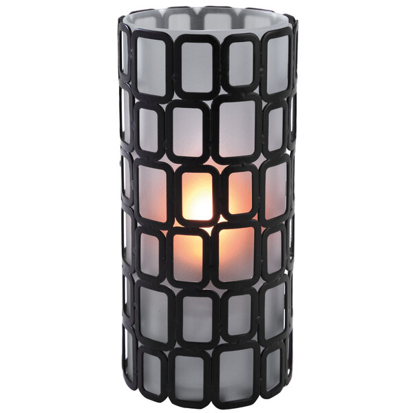 A Sterno Ayer Frost Lamp candle holder with a lit candle inside.