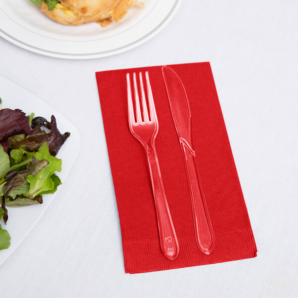 A fork and knife on a Classic Red 3-ply guest towel.