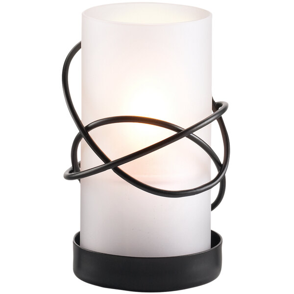 A Sterno Oleana frost lamp with a white candle in a black wire stand.