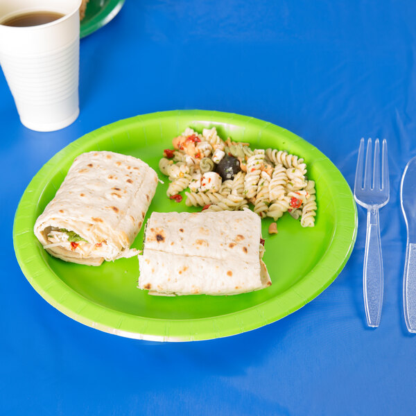 A Creative Converting Fresh Lime Green paper plate with a burrito and a tortilla wrap on it.