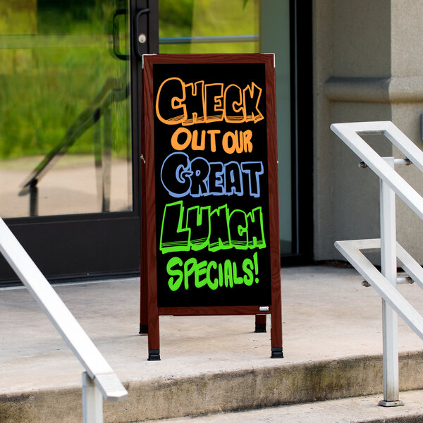 A cherry stained solid oak A-Frame sidewalk sign with a black porcelain board.