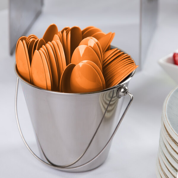 A bucket of Sunkissed Orange plastic spoons and forks.