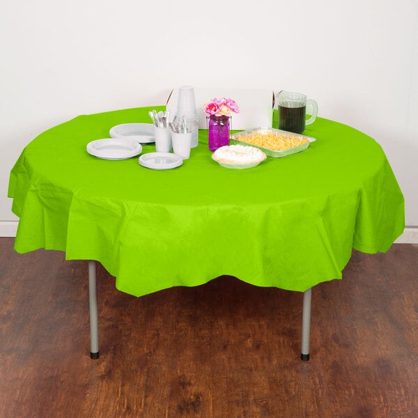A table with a Fresh Lime Green Creative Converting tablecloth, plates, and cups.