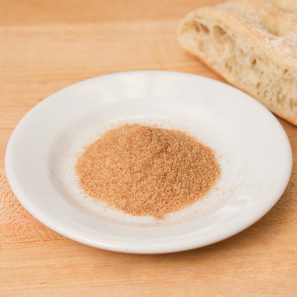 A bowl of Regal Cinnamon Sugar on a wooden surface.