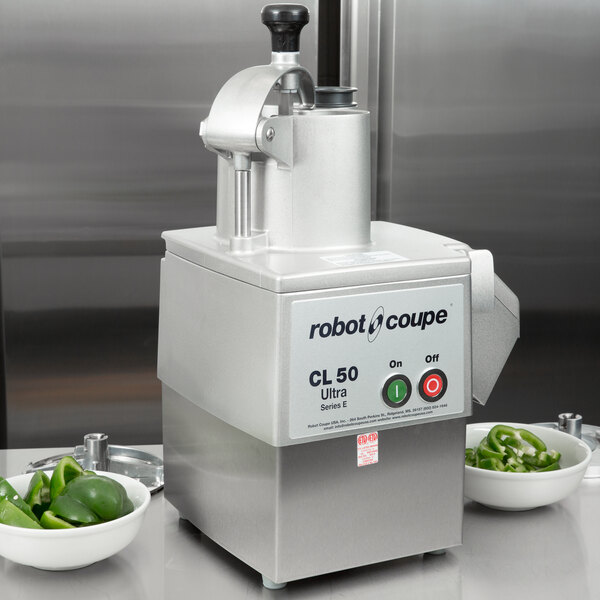 A Robot Coupe CL50 Ultra food processor dicing green peppers.